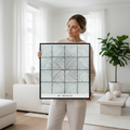 Woman holding A3 flowing curves zentangle print in minimalist white Scandinavian interior